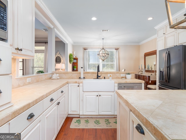 kitchen featuring pendant lighting, sink, dark hardwood / wood-style floors, a notable chandelier, and stainless steel appliances