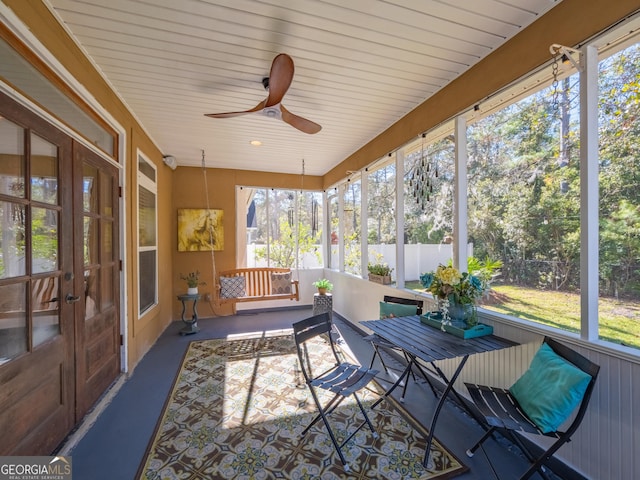 sunroom featuring ceiling fan