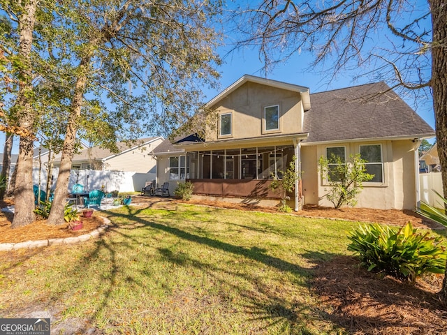 back of property featuring a lawn and a sunroom