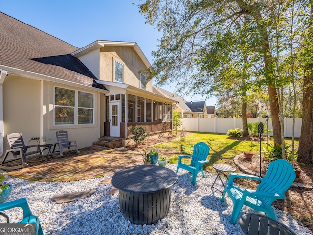 view of patio featuring a sunroom