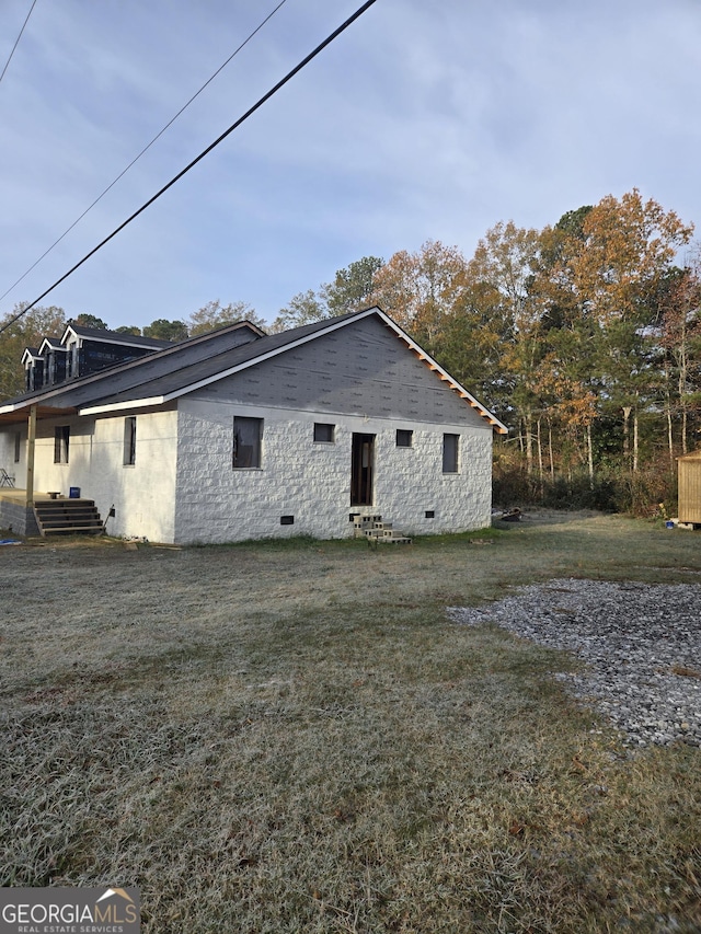 view of property exterior with a lawn