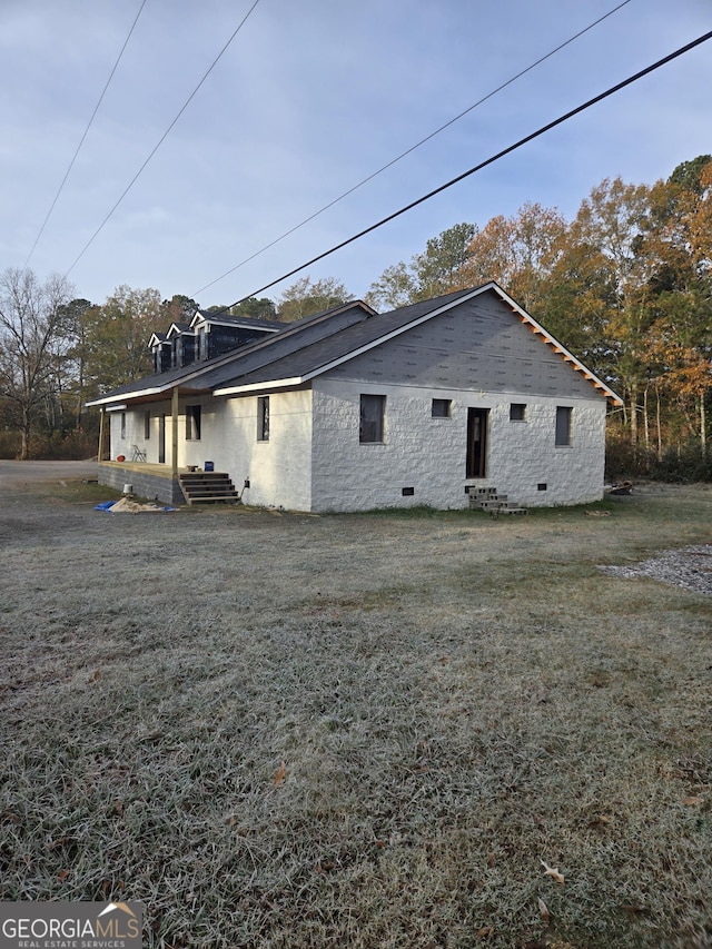 rear view of property with a lawn