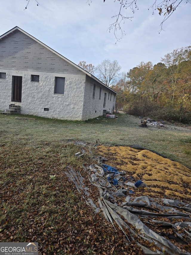 view of property exterior featuring a lawn