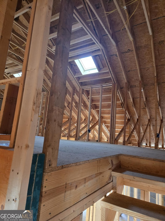 unfinished attic featuring a skylight