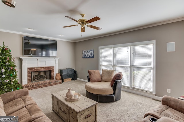 carpeted living room with a fireplace, crown molding, ceiling fan, and a healthy amount of sunlight