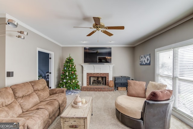 carpeted living room with a fireplace, ceiling fan, and ornamental molding