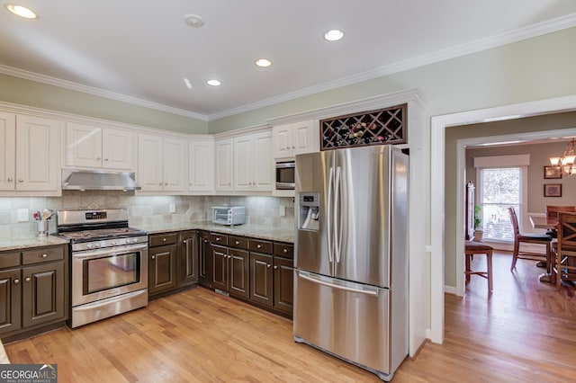 kitchen featuring dark brown cabinets, light wood-type flooring, white cabinetry, and stainless steel appliances