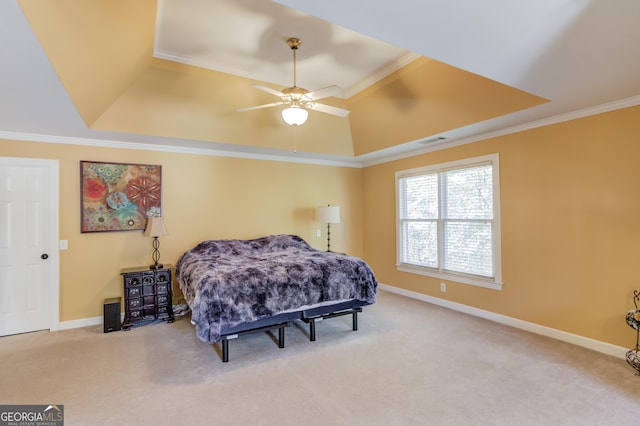 bedroom featuring carpet flooring, ceiling fan, a raised ceiling, and ornamental molding