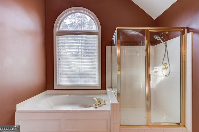 bathroom featuring separate shower and tub and vaulted ceiling