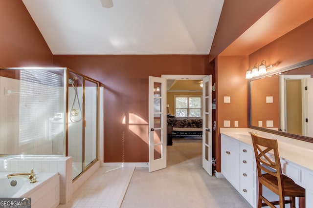 bathroom with plus walk in shower, french doors, vanity, and lofted ceiling