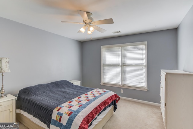 bedroom featuring ceiling fan and light carpet