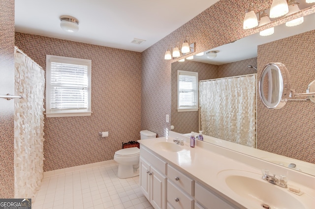 bathroom with tile patterned flooring, vanity, and toilet