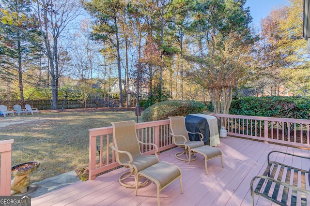 deck featuring a yard and a grill