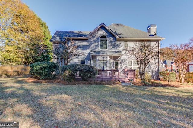 exterior space with a wooden deck and a front lawn