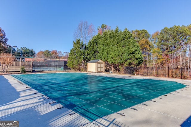 view of swimming pool with a storage shed