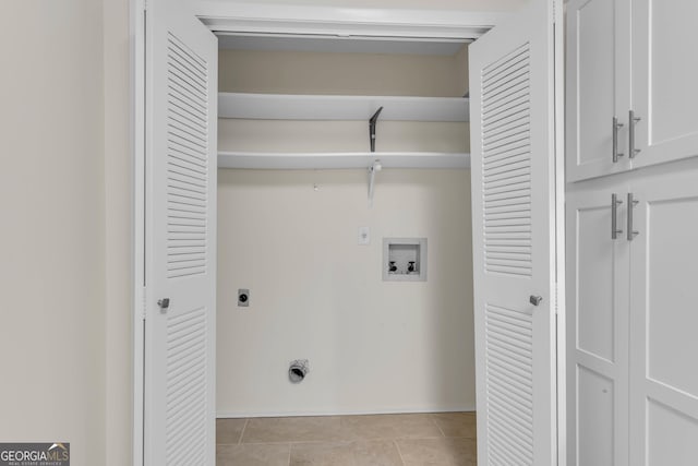 washroom featuring hookup for an electric dryer, light tile patterned floors, and washer hookup