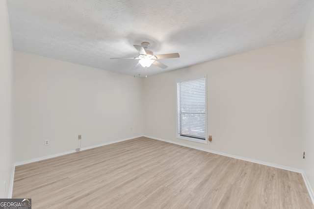 spare room featuring ceiling fan, a textured ceiling, and light wood-type flooring