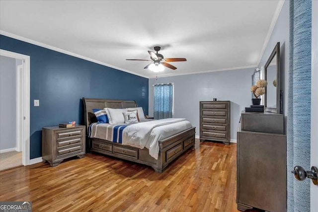 bedroom with wood-type flooring, ceiling fan, and ornamental molding