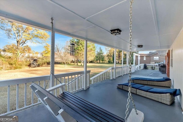 wooden terrace with covered porch and a grill