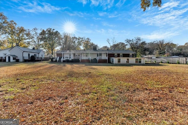 rear view of house with a lawn