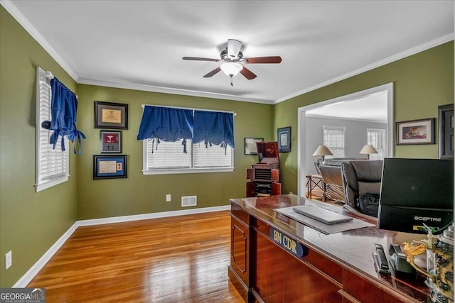 home office featuring ceiling fan, light wood-type flooring, plenty of natural light, and ornamental molding