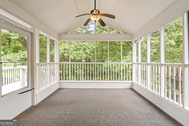 unfurnished sunroom featuring lofted ceiling, ceiling fan, and a healthy amount of sunlight