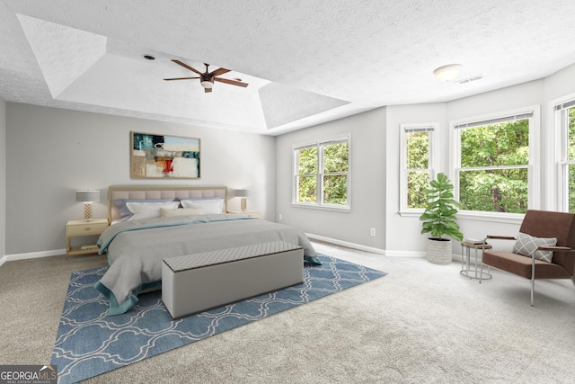 bedroom with carpet flooring, ceiling fan, and a textured ceiling