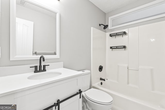 full bathroom with vanity, toilet, a textured ceiling, and bathing tub / shower combination