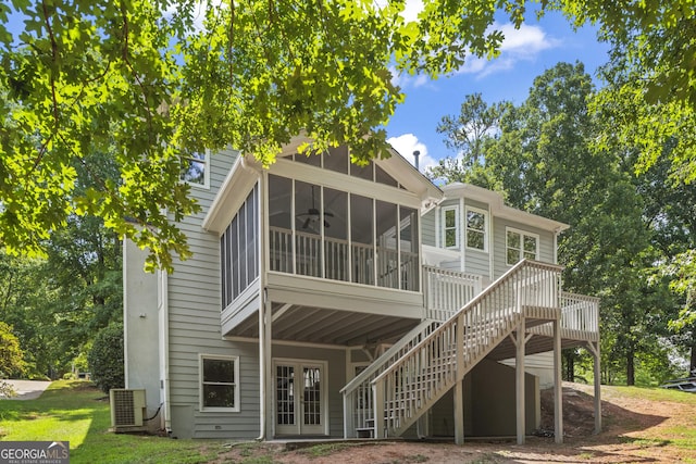 rear view of house featuring french doors, central AC unit, and a sunroom