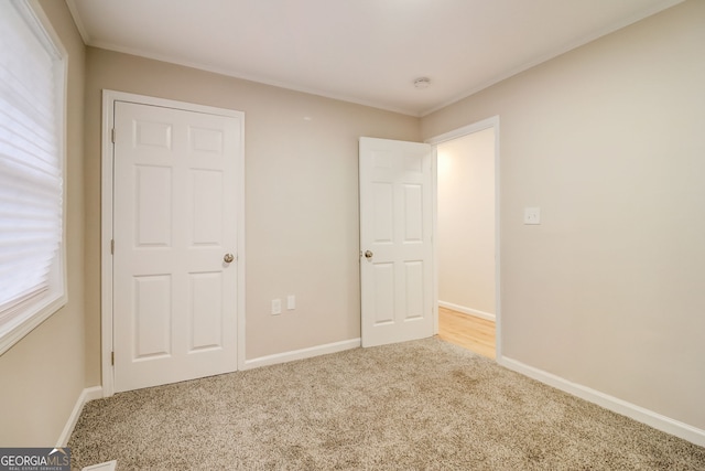 unfurnished bedroom featuring light carpet