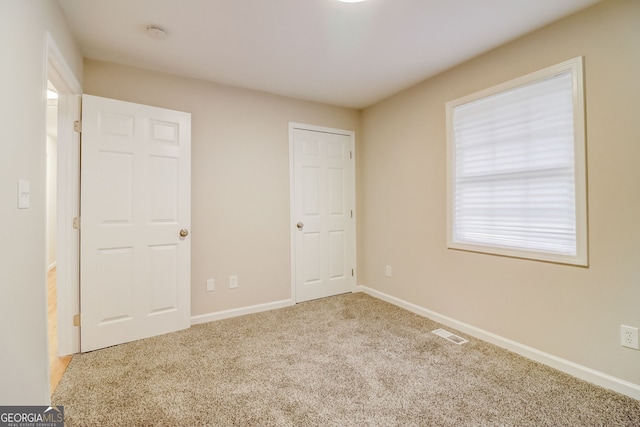 unfurnished bedroom with carpet flooring