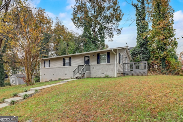 view of front of house with a front lawn and a storage shed