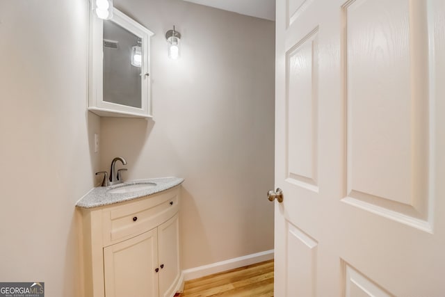 bathroom with vanity and hardwood / wood-style flooring