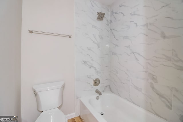 bathroom with tiled shower / bath combo, toilet, and wood-type flooring