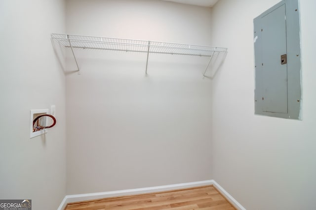 spacious closet with hardwood / wood-style floors and electric panel