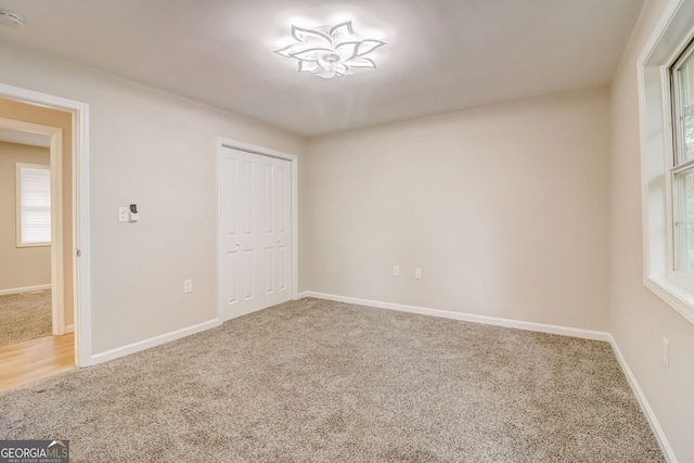 unfurnished bedroom featuring carpet and a closet