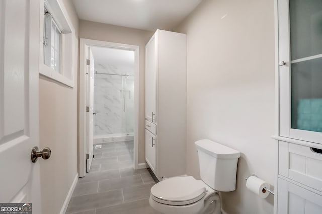 bathroom featuring toilet and walk in shower