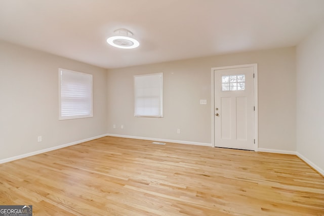 foyer entrance with light hardwood / wood-style floors