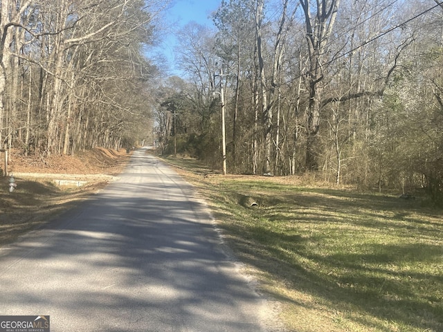 view of street with a wooded view