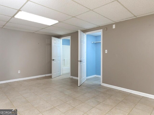 basement with a paneled ceiling