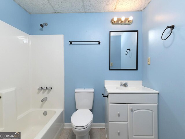 full bathroom featuring shower / bathing tub combination, a drop ceiling, vanity, and toilet