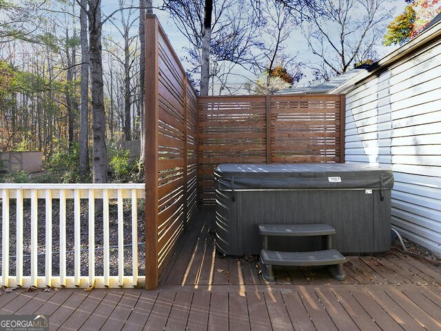 wooden deck with a hot tub