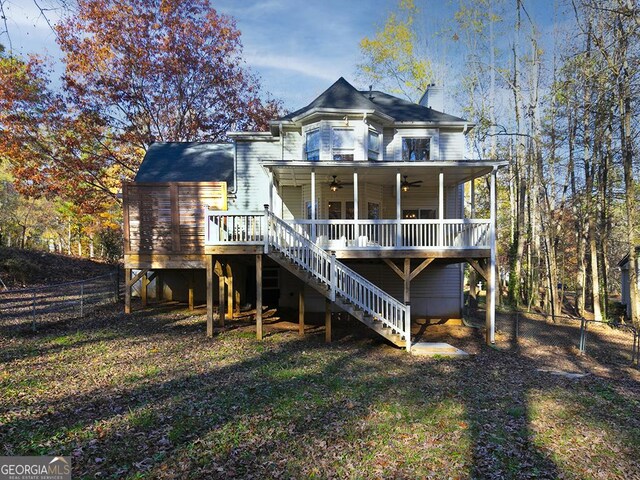 back of property with a deck and ceiling fan