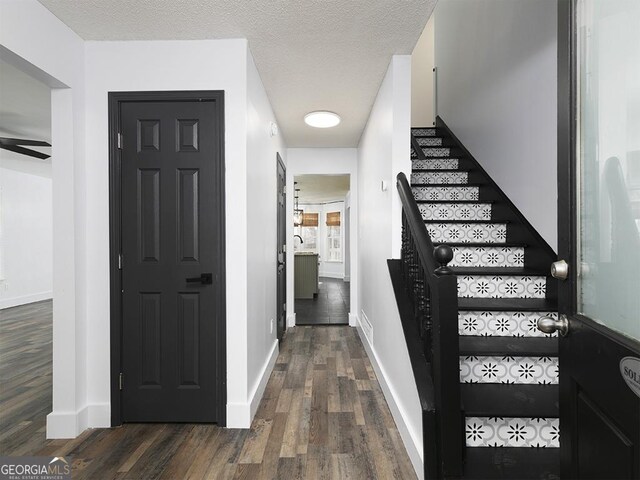 interior space with dark hardwood / wood-style floors and a textured ceiling