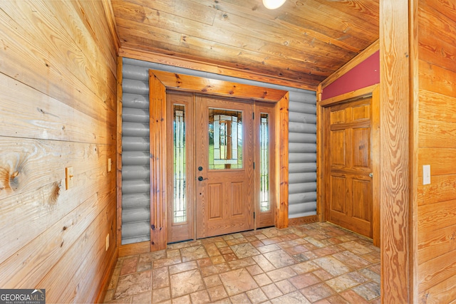 entryway with wooden ceiling, log walls, and vaulted ceiling