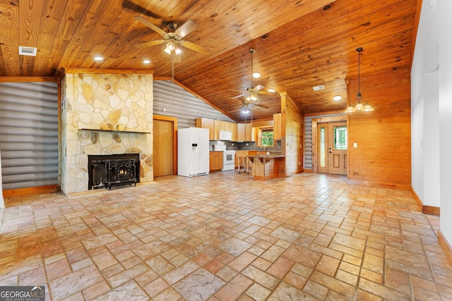unfurnished living room featuring wood ceiling, a ceiling fan, visible vents, and a fireplace