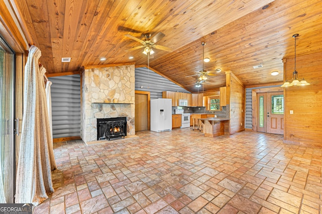 unfurnished living room featuring wood walls, wooden ceiling, a fireplace, and vaulted ceiling