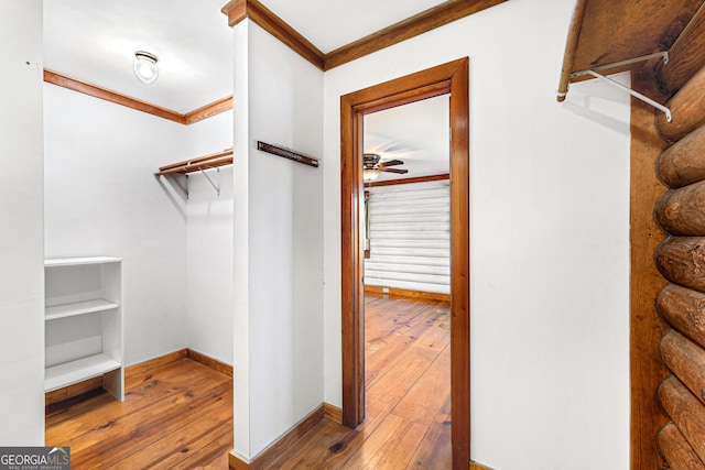 spacious closet with wood-type flooring and a ceiling fan