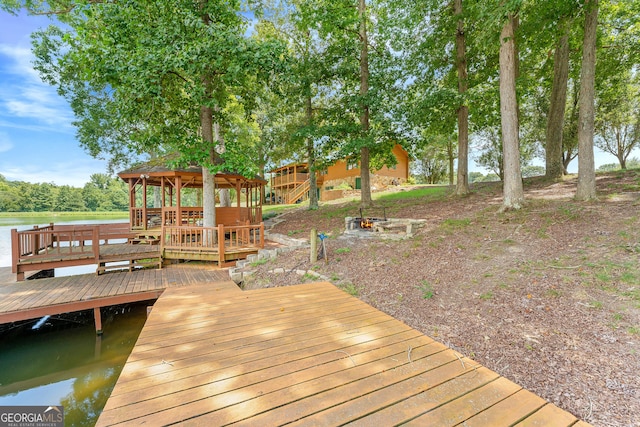 dock area with a gazebo and a deck with water view