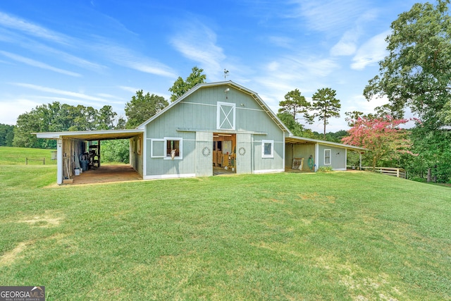 back of house with a lawn and an outdoor structure